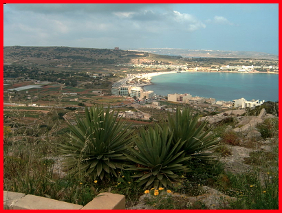 A view of Mellieha Bay from Mellieha Town.  Note the Red Tower on Marfa Ridge and in the distance the Island of Gozo .